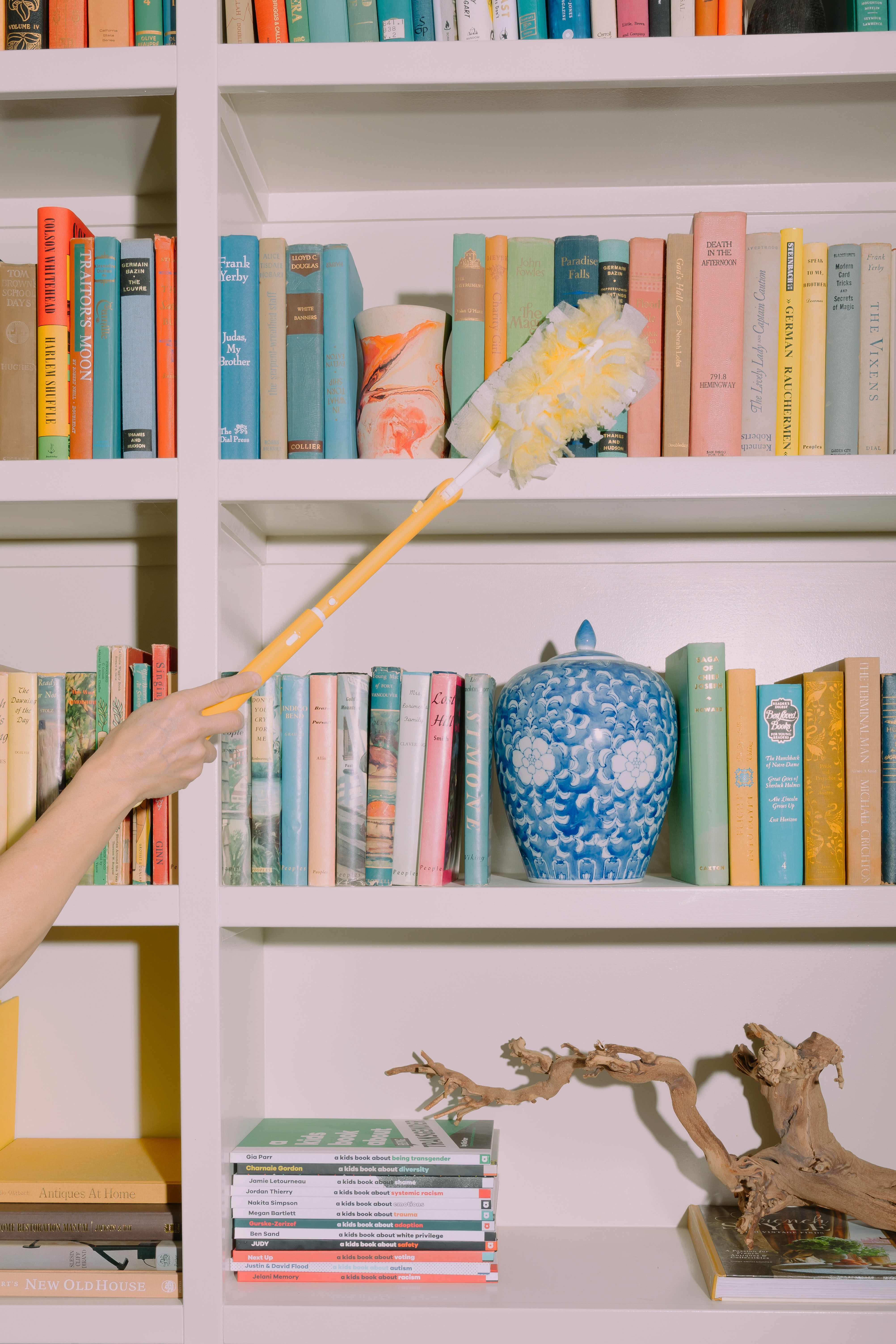 Dusting a bookshelf